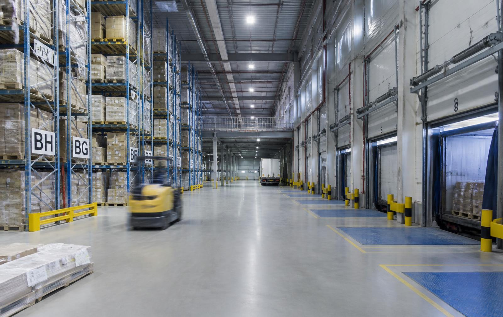 Warehouse interior with racking, forklift and truck loading docks